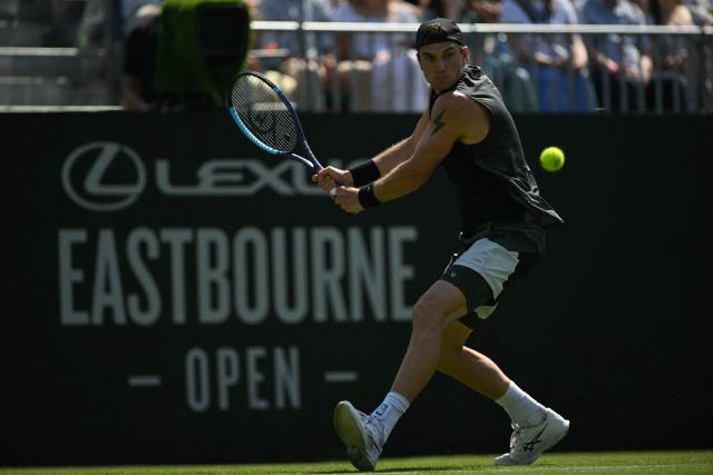 Britain's Jack Draper returns to US player Marcos Giron during their men's singles round of 32 tennis match on day one of the Lexus Eastbourne Open at Devonshire Park, Eastbourne, on the south coast of England on June 22, 2026. (Photo by Glyn KIRK / AFP)