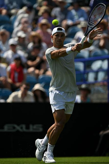 US player Marcos Giron returns to Britain's Jack Draper during their men's singles round of 32 tennis match on day one of the Lexus Eastbourne Open at Devonshire Park, Eastbourne, on the south coast of England on June 22, 2026. (Photo by Glyn KIRK / AFP)