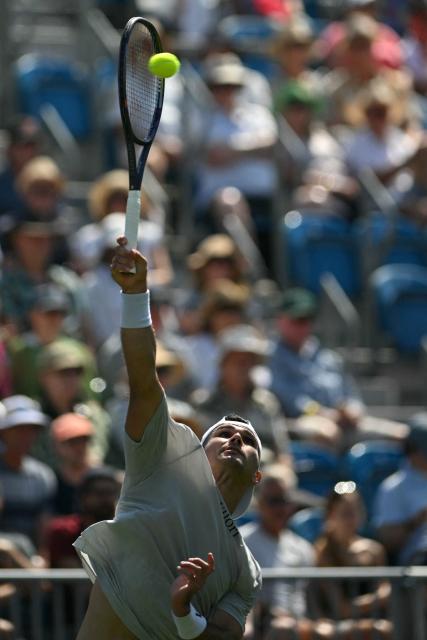 US player Marcos Giron serves to Britain's Jack Draper during their men's singles round of 32 tennis match on day one of the Lexus Eastbourne Open at Devonshire Park, Eastbourne, on the south coast of England on June 22, 2026. (Photo by Glyn KIRK / AFP)