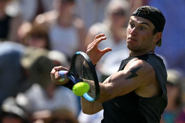 Britain's Jack Draper returns to US player Marcos Giron during their men's singles round of 32 tennis match on day one of the Lexus Eastbourne Open at Devonshire Park, Eastbourne, on the south coast of England on June 22, 2026. (Photo by Glyn KIRK / AFP)
