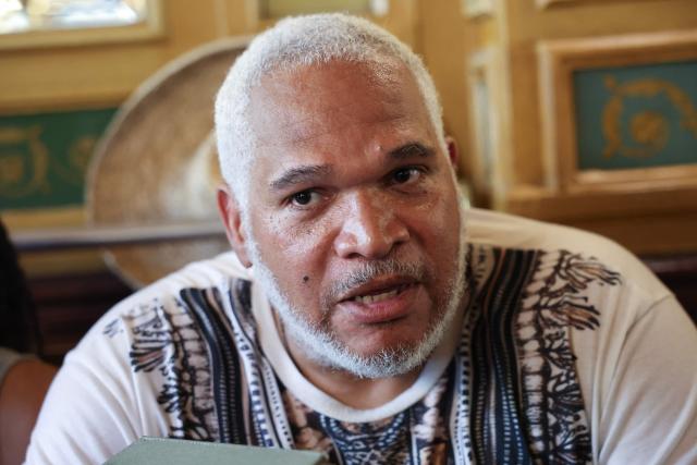 President of the Association Ultramarin Doubout, Andre Bazin delivers remarks to journalists in regards to a court decision on health issues allegedly linked to chlordecone persticide use, in a cafe near the Palais de Justice courthouse in Paris, on June 22, 2026. After 20 years of legal proceedings, the Paris Court of Appeal upheld a dismissal of the case on June 22, effectively ruling out any reopening of the criminal investigation into the health scandal involving a pesticide used in the French Caribbean despite warnings about its toxicity. (Photo by Charlotte SIEMON / AFP)