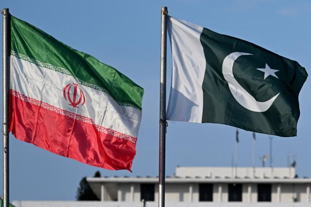 The national flags of Pakistan and Iran flutter outside the President House in Islamabad on June 22, 2026 on the eve of Iran's President Masoud Pezeshkian's visit to Pakistan amid the US-Iran peace talks. Iranian President Masoud Pezeshkian will travel to Pakistan on June 23, state media reported, following talks between Tehran and Washington in Switzerland which were mediated by Islamabad. (Photo by Aamir QURESHI / AFP)