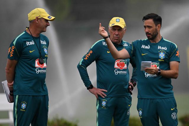 Brazil's Italian head coach Carlo Ancelotti (C) speaks with his assistants during a training session at the Columbia Park Training Facility in Morristown, New Jersey on June 22, 2026, during the 2026 World Cup football tournament.  (Photo by Mauro PIMENTEL / AFP)