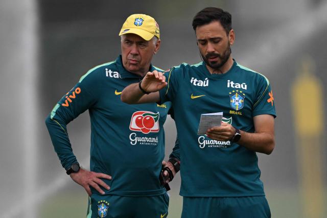 Brazil's Italian head coach Carlo Ancelotti (L) listens to his assistant during a training session at the Columbia Park Training Facility in Morristown, New Jersey on June 22, 2026, during the 2026 World Cup football tournament.  (Photo by Mauro PIMENTEL / AFP)