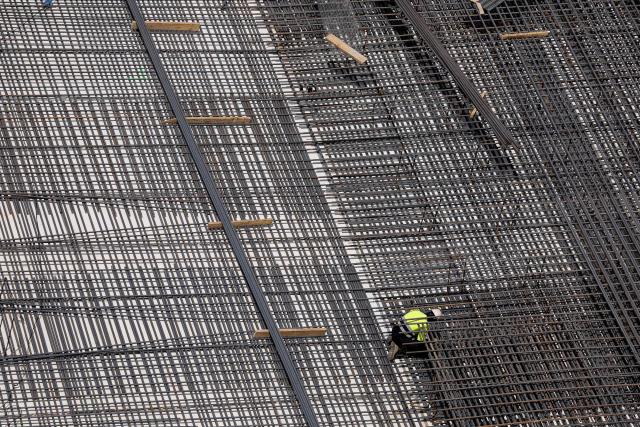 A worker installs metallic structure at a construction site for a bus terminal in Madrid on June 22, 2026, during the heat wave affecting the Iberian Peninsula. National weather agency AEMET issued an orange heat warning – the second-highest level - for the Madrid region, with temperatures forecast to reach 40C. Large parts of Spain experience unusually high temperatures for June as a mass of hot air from North Africa moves across the Iberian Peninsula. (Photo by OSCAR DEL POZO / AFP)