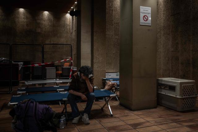 A man sits on a camp bed at an emergency heatwave relief centre opened by the city of Bordeaux as France experiences a heatwave, in Bordeaux, south-western France, on June 22, 2026. The latest bout of exceptionally high temperatures to hit Europe has seen outdoor events cancelled, transport disrupted, schools shut and office workers told to work from home, as the authorities issued health alerts to protect the elderly and vulnerable. In France, the epicentre of the weather anomaly, 54 of the country's 96 mainland departments were on the highest heat alert, with temperatures forecast to climb up to 43C in the southwestern city of Bordeaux and 39C in the capital Paris, said national weather service Meteo-France. (Photo by Philippe LOPEZ / AFP)