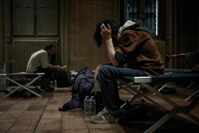 Men sit on a camp beds at an emergency heatwave relief centre opened by the city of Bordeaux as France experiences a heatwave, in Bordeaux, south-western France, on June 22, 2026. The latest bout of exceptionally high temperatures to hit Europe has seen outdoor events cancelled, transport disrupted, schools shut and office workers told to work from home, as the authorities issued health alerts to protect the elderly and vulnerable. In France, the epicentre of the weather anomaly, 54 of the country's 96 mainland departments were on the highest heat alert, with temperatures forecast to climb up to 43C in the southwestern city of Bordeaux and 39C in the capital Paris, said national weather service Meteo-France. (Photo by Philippe LOPEZ / AFP)