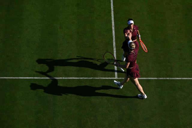 Brazil's Luisa Setfani and Canada's Gabriela Dabrowski high five during their women's doubles round of 16 tennis match on day one of the Lexus Eastbourne Open at Devonshire Park, Eastbourne, on the south coast of England on June 22, 2026. (Photo by Glyn KIRK / AFP)