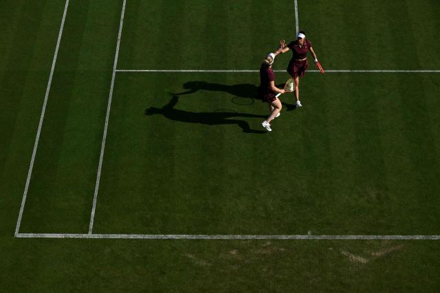 Brazil's Luisa Setfani and Canada's Gabriela Dabrowski high five during their women's doubles round of 16 tennis match on day one of the Lexus Eastbourne Open at Devonshire Park, Eastbourne, on the south coast of England on June 22, 2026. (Photo by Glyn KIRK / AFP)