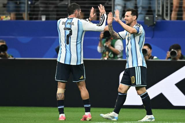 Argentina's forward #10 Lionel Messi (R) celebrates with Argentina's midfielder #07 Rodrigo De Paul after scoring the opening goal during the 2026 World Cup Group J football match between Argentina and Austria at the Dallas Stadium in Arlington on June 22, 2026.  (Photo by Paul ELLIS / AFP)