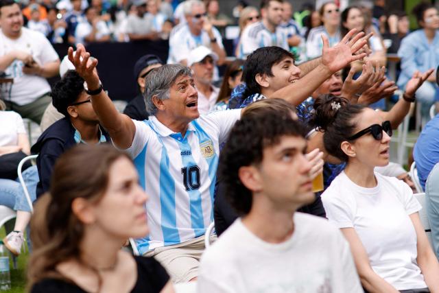 Fans react as they attend a watch party for the 2026 World Cup football tournament match between Argentina and Austria, at Hudson Yards Backyard in New York City on June 22, 2026. (Photo by Leonardo MUNOZ / AFP)