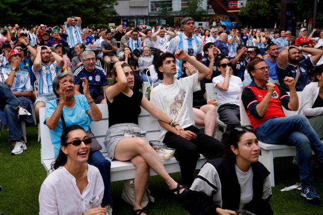 People react as they attend a watch party for the 2026 World Cup football tournament match between Argentina and Austria, at Hudson Yards Backyard in New York City on June 22, 2026. (Photo by Leonardo MUNOZ / AFP)