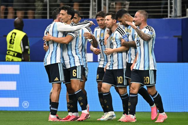 Argentina's forward #10 Lionel Messi celebrates with teammates after scoring the opening goal during the 2026 World Cup Group J football match between Argentina and Austria at the Dallas Stadium in Arlington on June 22, 2026.  (Photo by Paul ELLIS / AFP)