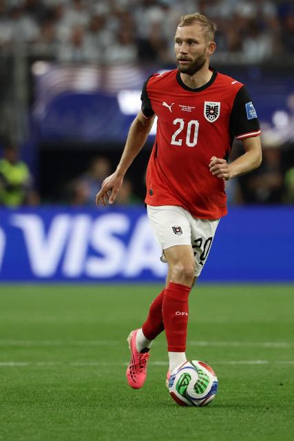 Austria's midfielder #20 Konrad Laimer runs with the ball during the 2026 World Cup Group J football match between Argentina and Austria at the Dallas Stadium in Arlington on June 22, 2026.  (Photo by Aric Becker / AFP)