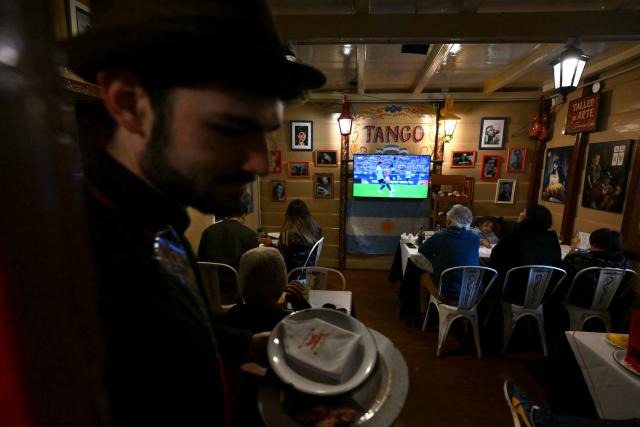 Argentina fans watchi the 2026 FIFA World Cup football match between Argentina and Austria on a TV at restaurant in Buenos Aires on June 22, 2026. (Photo by Luis ROBAYO / AFP)
