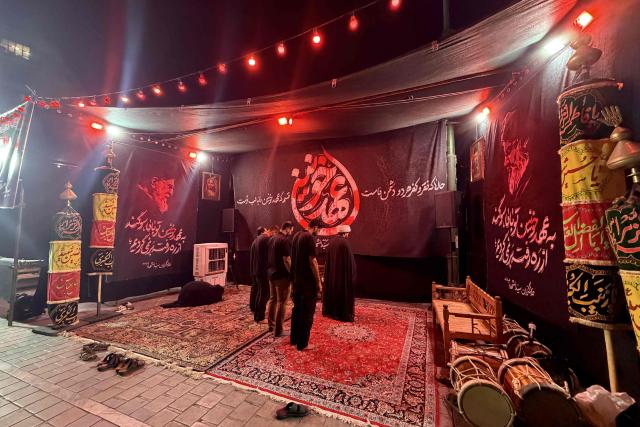 Mourners pray during Muharram during Muharram ceremonies ahead of Ashura, commemorating the death of Imam Hussein in Tehran on June 22, 2026. The Islamic month of Muharram, culminating with Ashura on its tenth day, is one of the most important commemorations for Shia Muslims around the world, marking the seventh-century killing of the grandson of Islam's Prophet Mohamed, the Imam Hussein. (Photo by ATTA KENARE / AFP) / 