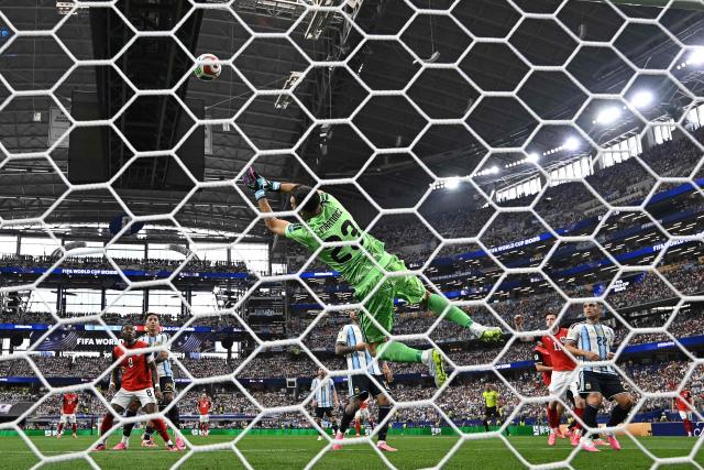 Argentina's goalkeeper #23 Emiliano Martinez jumps to deflect the ball  during the 2026 World Cup Group J football match between Argentina and Austria at the Dallas Stadium in Arlington on June 22, 2026.  (Photo by Paul ELLIS / AFP)