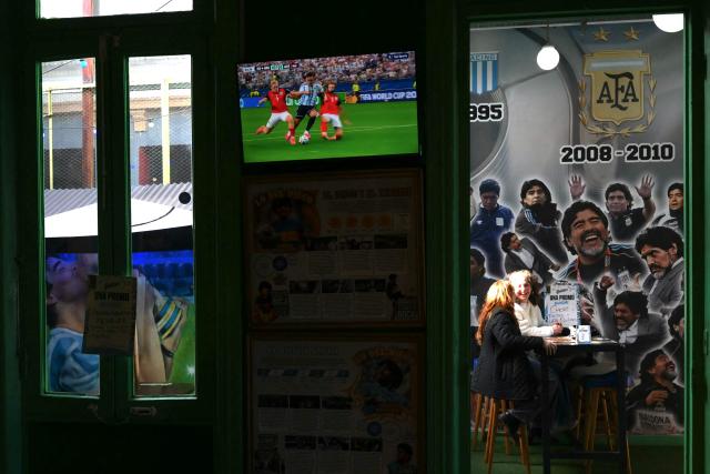 A TV shows the 2026 FIFA World Cup football match between Argentina and Austria at a restaurant in Buenos Aires on June 22, 2026. (Photo by Luis ROBAYO / AFP)