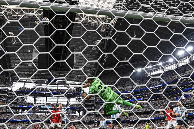 Argentina's goalkeeper #23 Emiliano Martinez jumps to deflect the ball during the 2026 World Cup Group J football match between Argentina and Austria at the Dallas Stadium in Arlington on June 22, 2026.  (Photo by Paul ELLIS / AFP)