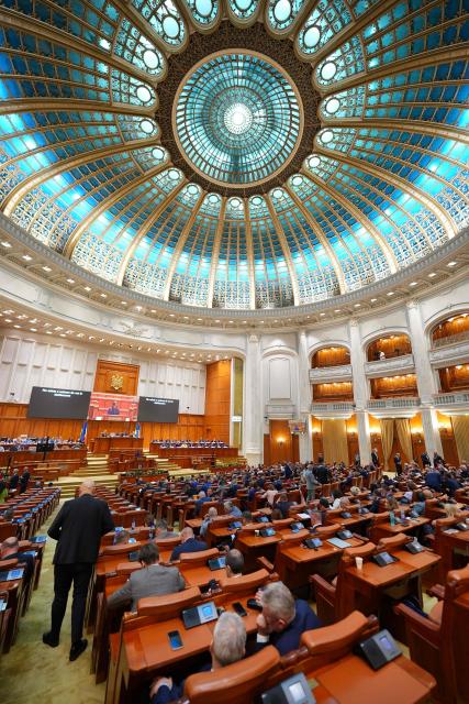 The plenary hall of the Romanian Parliament is pictured in Bucharest on June 22, 2026, as the parliament holds a joint session of the Chamber of Deputies and the Senate for a vote of confidence to invest the new Vestea Government. Romania's parliament votes on June 22 on the new liberal prime minister as political turmoil has gripped the EU and NATO member bordering Ukraine. After the first new prime minister designate Ilie Bolojan dropped out, Romanian President Nicusor Dan tapped politician Adrian Vestea, a 52-year-old fellow Liberal, on June 14 to form the next government. Vestea's own party, led by Bolojan, has so far refused to back the prime minister designate, threatening him with expulsion from the party. Vestea, who is a former mayor and regional governmental leader and has served as development minister in a previous Romanian government, needs 233 votes across both houses of parliament to form a government. (Photo by Mihai Barbu / AFP)