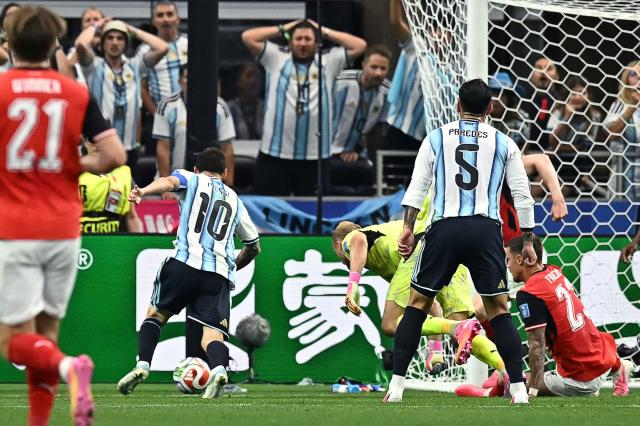 Argentina's forward #10 Lionel Messi (L) scores his team's second goal during the 2026 World Cup Group J football match between Argentina and Austria at the Dallas Stadium in Arlington on June 22, 2026.  (Photo by Paul ELLIS / AFP)