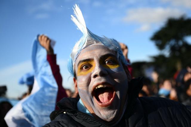An Argentina fan celebrates a goal scored by Argentina’s forward Lionel Messi as they watch the 2026 FIFA World Cup Group J football match between Argentina and Austria on a giant screen in Buenos Aires on June 22, 2026. (Photo by Luis ROBAYO / AFP)