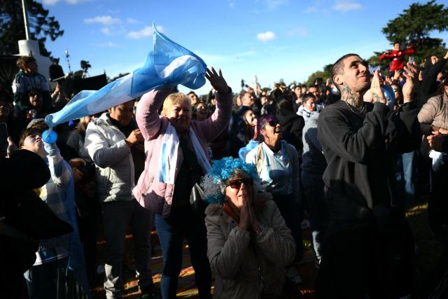 Argentina fans celebrate a goal scored by Argentina’s forward Lionel Messi as they watch the 2026 FIFA World Cup Group J football match between Argentina and Austria on a giant screen in Buenos Aires on June 22, 2026. (Photo by Luis ROBAYO / AFP)