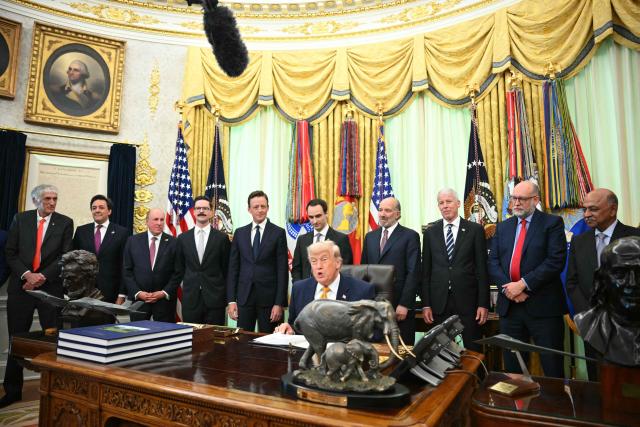 US President Donald Trump (C) speaks before signing executive orders in the Oval Office of the White House in Washington, DC, on June 22, 2026. (Photo by Mandel NGAN / AFP)