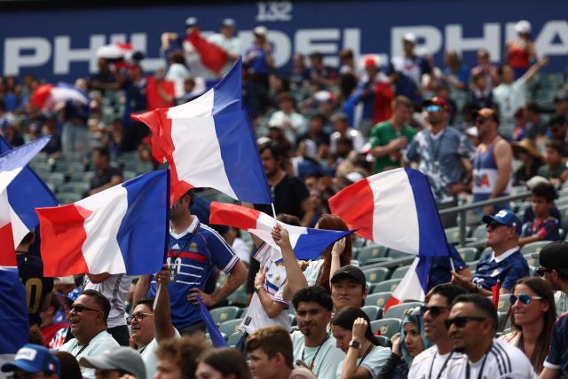 French fans wave flags ahead of the 2026 World Cup Group I football match between France and Iraq at the Philadelphia Stadium in Philadelphia on June 22, 2026.  (Photo by FRANCK FIFE / AFP)