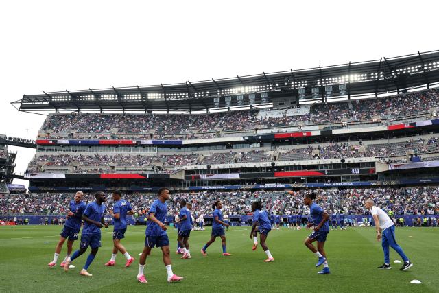 France's players take part in the warm-up ahead of the 2026 World Cup Group I football match between France and Iraq at the Philadelphia Stadium in Philadelphia on June 22, 2026.  (Photo by FRANCK FIFE / AFP)