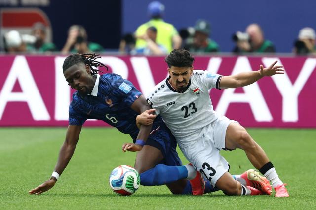 France's midfielder #06 Manu Kone and Iraq's defender #23 Merchas Doski fight for the ball during the 2026 World Cup Group I football match between France and Iraq at the Philadelphia Stadium in Philadelphia on June 22, 2026.  (Photo by FRANCK FIFE / AFP)