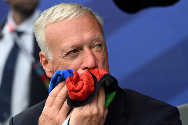 France's head coach Didier Deschamps wipes the sweat off his face ahead of the 2026 World Cup Group I football match between France and Iraq at the Philadelphia Stadium in Philadelphia on June 22, 2026.  (Photo by ROBERTO SCHMIDT / AFP)