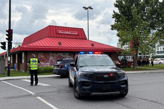 Police are seen near a kosher restaurant in Montreal on June 22, 2026, after a shooting nearby which left three people dead. A midday shooting in Montreal killed three people on Monday, including a police officer, a civilian, and the alleged gunman, triggering rare alarm in the Canadian city. The bloodshed occurred in a partly Jewish neighborhood that includes kosher markets and restaurants, but police declined to comment on what the motive might have been and whether the incident amounted to a hate crime or act of terror. (Photo by Daphné LEMELIN / AFP)
