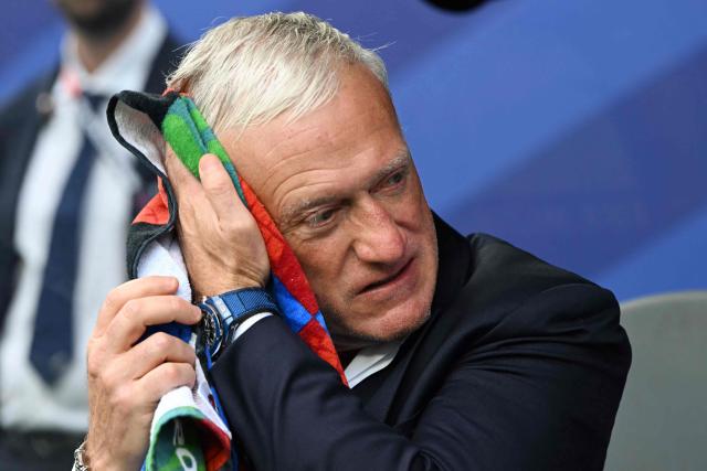 France's head coach Didier Deschamps wipes the sweat off his face ahead of the 2026 World Cup Group I football match between France and Iraq at the Philadelphia Stadium in Philadelphia on June 22, 2026.  (Photo by ROBERTO SCHMIDT / AFP)