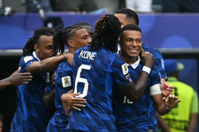 France's forward #10 Kylian Mbappe celebrates scoring his team's first goal with teammates during the 2026 World Cup Group I football match between France and Iraq at the Philadelphia Stadium in Philadelphia on June 22, 2026.  (Photo by MAURO PIMENTEL / AFP)