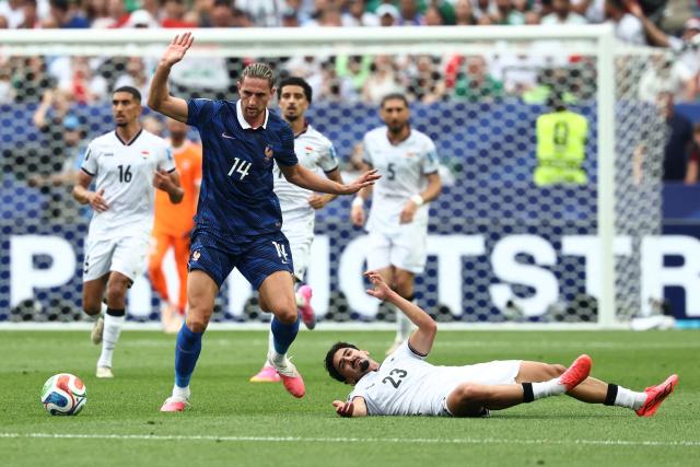 France's midfielder #14 Adrien Rabiot and Iraq's defender #23 Merchas Doski fight for the ball during the 2026 World Cup Group I football match between France and Iraq at the Philadelphia Stadium in Philadelphia on June 22, 2026.  (Photo by FRANCK FIFE / AFP)