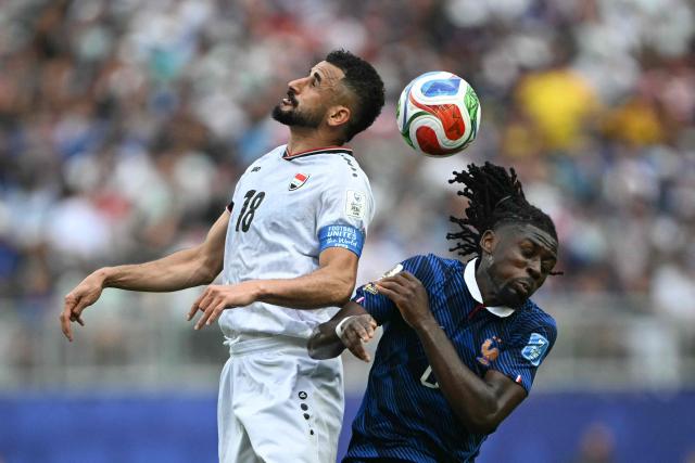 Iraq's forward #18 Aymen Hussein (L) and France's midfielder #06 Manu Kone fight for the ball during the 2026 World Cup Group I football match between France and Iraq at the Philadelphia Stadium in Philadelphia on June 22, 2026.  (Photo by Mauro PIMENTEL / AFP)
