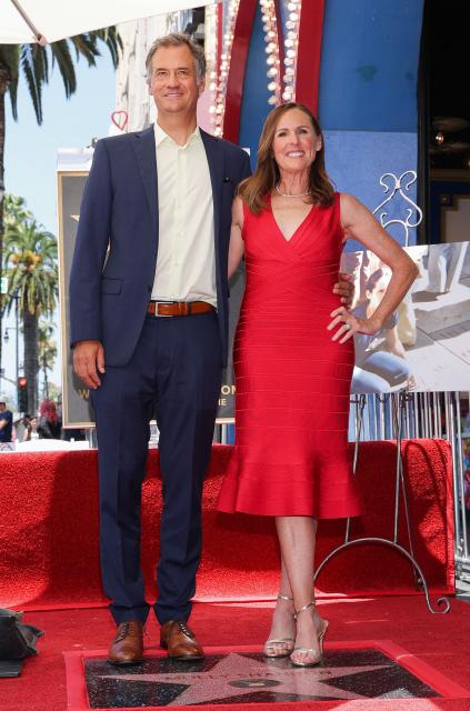 US actress Molly Shannon and her husband, artist Fritz Chesnut, pose on Shannon's newly unveiled star during her Hollywood Walk of Fame ceremony in the Hollywood neighborhood of Los Angeles on June 22, 2026. (Photo by VALERIE MACON / AFP)