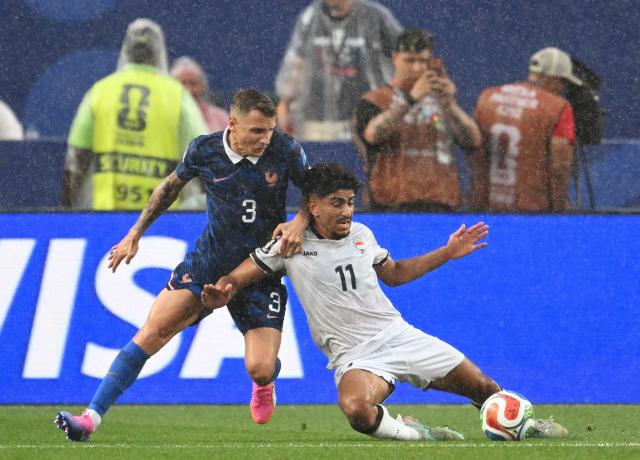 France's defender #03 Lucas Digne and Iraq's forward #11 Ahmed Qasim fight for the ball during the 2026 World Cup Group I football match between France and Iraq at the Philadelphia Stadium in Philadelphia on June 22, 2026.  (Photo by ROBERTO SCHMIDT / AFP)