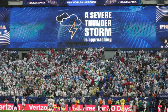A screen shows a severe thunder storm warning during the 2026 World Cup Group I football match between France and Iraq at the Philadelphia Stadium in Philadelphia on June 22, 2026.  (Photo by FRANCK FIFE / AFP)