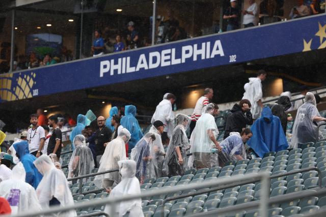 Fans wear raincoats at halftime of the 2026 World Cup Group I football match between France and Iraq at the Philadelphia Stadium in Philadelphia on June 22, 2026.  (Photo by FRANCK FIFE / AFP)
