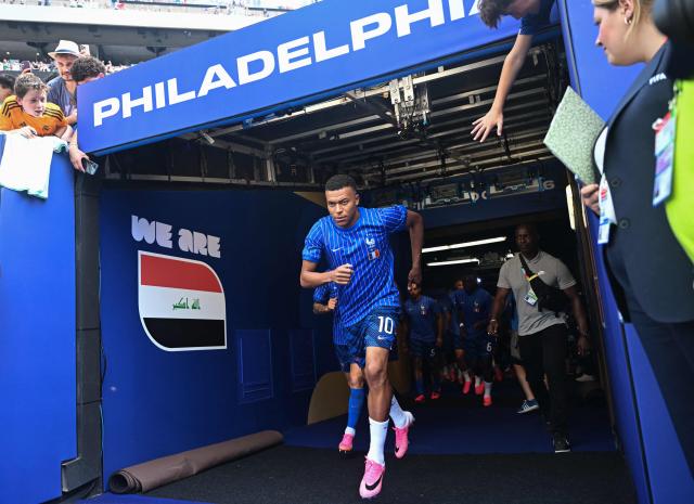 France's forward #10 Kylian Mbappe walks onto the picth to warm up ahead of the 2026 World Cup Group I football match between France and Iraq at the Philadelphia Stadium in Philadelphia on June 22, 2026.  (Photo by Jewel SAMAD / AFP)