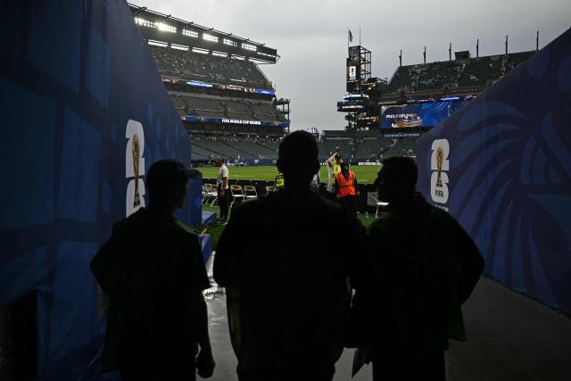 FIFA workers look at the rain at halftime during the 2026 World Cup Group I football match between France and Iraq at Philadelphia Stadium in Philadelphia on June 22, 2026.  (Photo by Mauro PIMENTEL / AFP)