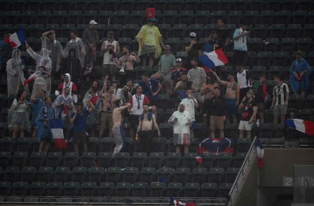 France's fans wait in the rain at halftime during the 2026 World Cup Group I football match between France and Iraq at Philadelphia Stadium in Philadelphia on June 22, 2026.  (Photo by Mauro PIMENTEL / AFP)