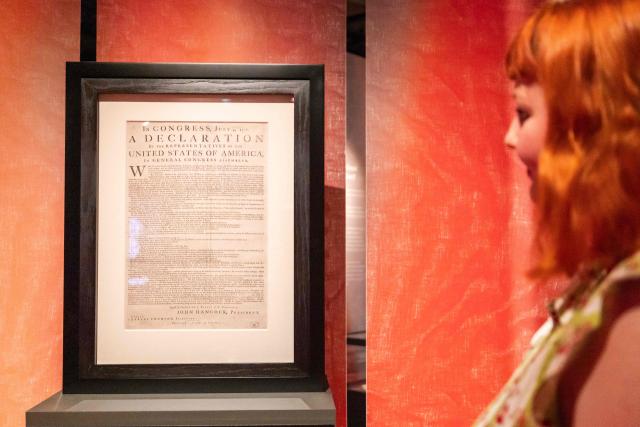 A member of staff views the United States of America Declaration of Independence, printed by John Dunlap in Philadelphia on the night of 4 July, 1776, at a photocall ahead of the exhibition: Revolution 250: America's Independence Story 1763-1783 at The National Archives in Kew, west London on June 22, 2026. (Photo by Brook Mitchell / AFP)
