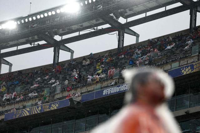 Fans wear raincoats ahead of the 2026 World Cup Group I football match between Norway and Senegal at the New York/New Jersey Stadium in East Rutherford on June 22, 2026.  (Photo by CHARLY TRIBALLEAU / AFP)