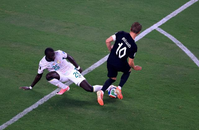 Senegal's defender #25 El Hadji Malick Diouf and Norway's midfielder #10 Martin Odegaard fight for the ball during the 2026 World Cup Group I football match between Norway and Senegal at the New York/New Jersey Stadium in East Rutherford on June 22, 2026. (Photo by Timothy A. CLARY / AFP)