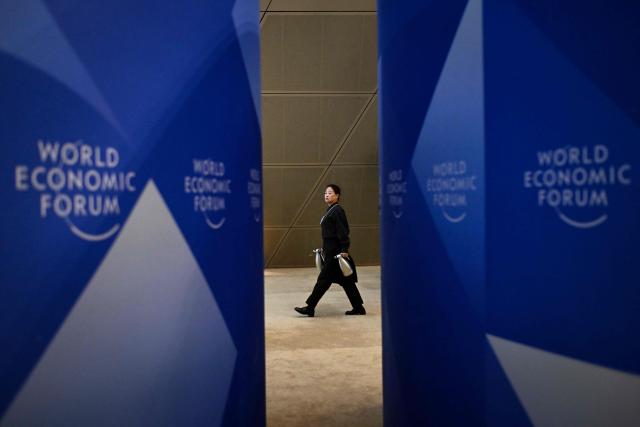 A hostess walks during the Dalian International Conference Centre during the World Economic Forum Annual Meeting of the New Champions in Dalian, China's Liaoning province, on June 23, 2026. (Photo by WANG Zhao / AFP)