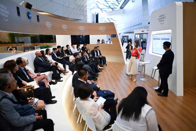 Attendees attend a seminar group at the Dalian International Conference Centre during the World Economic Forum Annual Meeting of the New Champions in Dalian, China's Liaoning province, on June 23, 2026. (Photo by WANG Zhao / AFP)