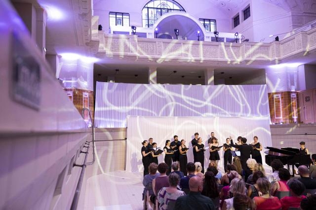 Members of the Choeur de l'Orchestre du Rhin perform during a dress rehearsal at the Bains Municipaux, a public bathing site with the historical monument status, in Strasbourg, eastern France, on June 22, 2026. (Photo by ROMEO BOETZLE / AFP)